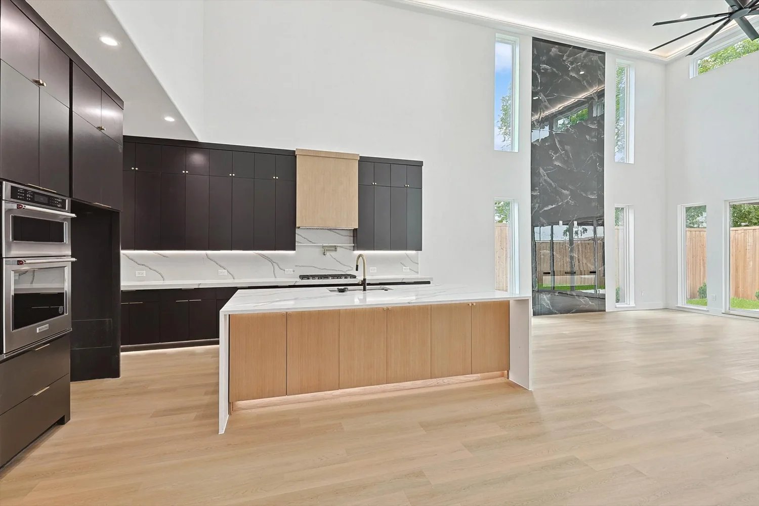 Bright new construction living room with a wall of windows